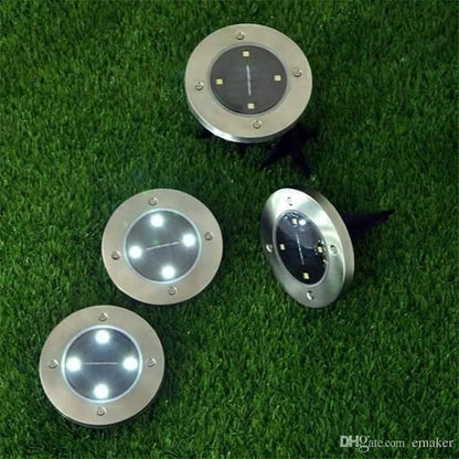 Četiri okrugle solarne lampe za osvetljavanje dvorišta i prilaza.